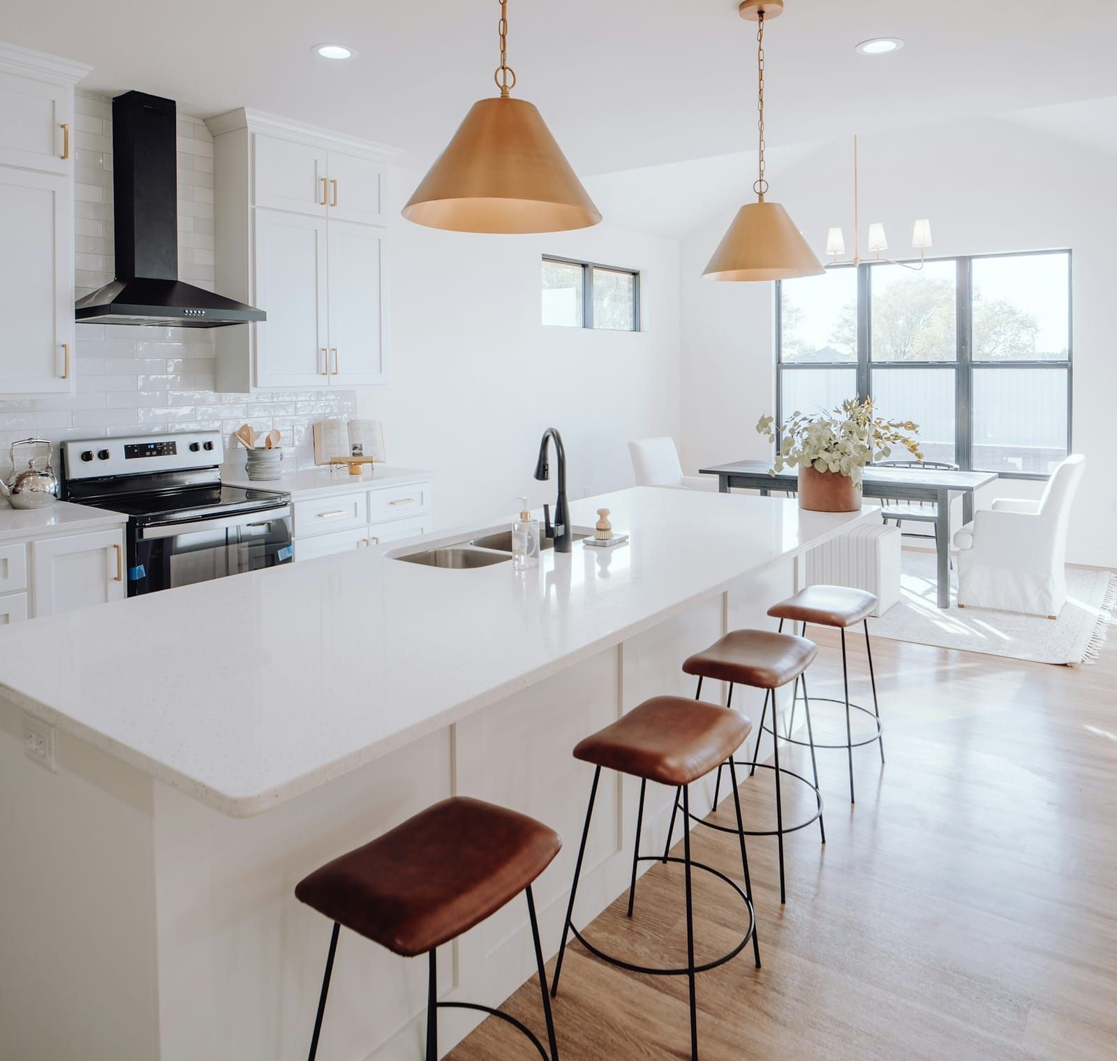 Bright modern kitchen with pendant and recessed lighting